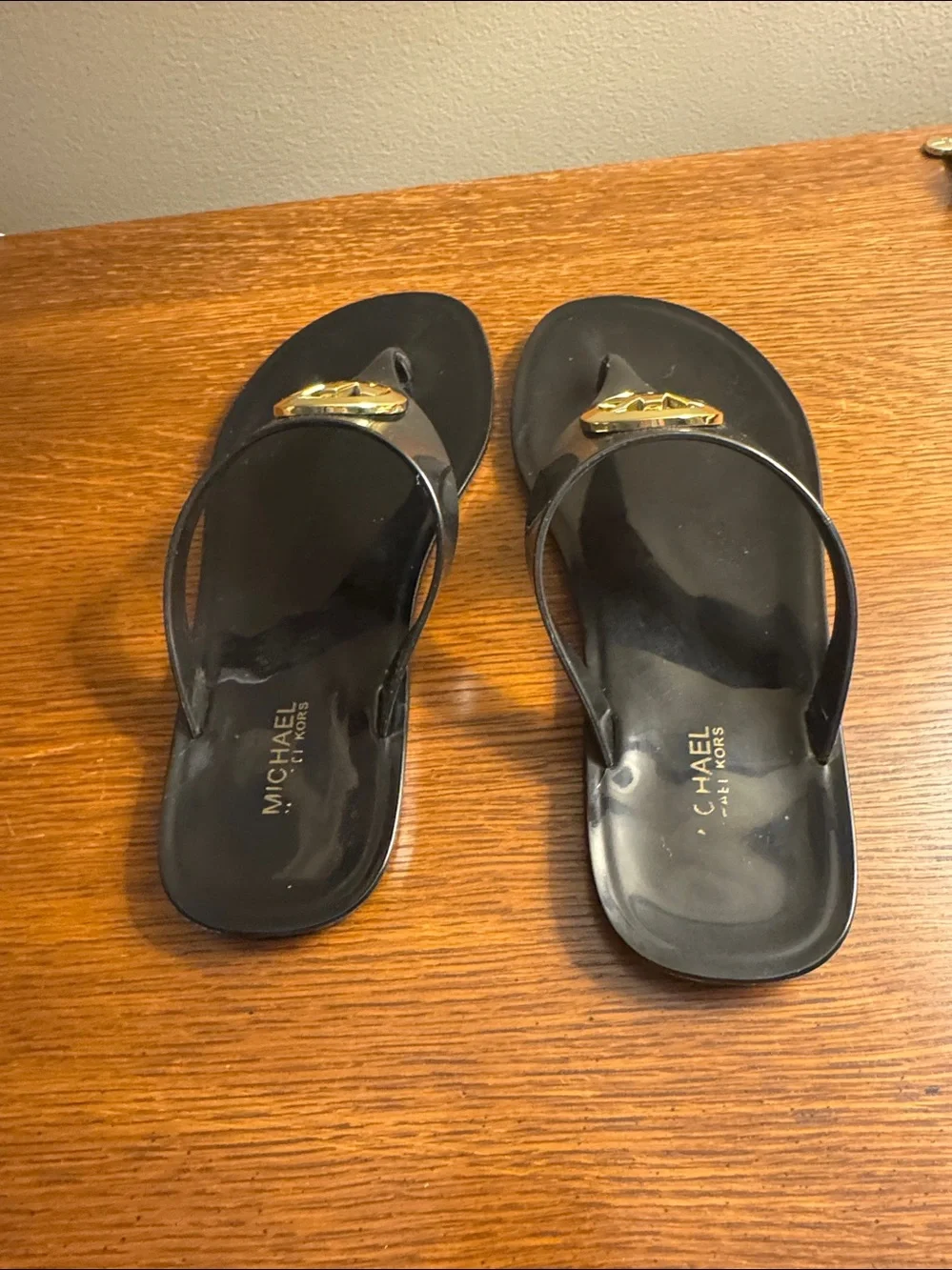 Michael Kors Black Flip Flop Sandals with Gold MK Medallion